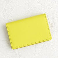 Neon Yellow: A small leather cardholder wallet in neon yellow.
