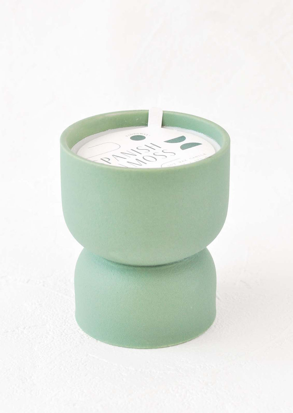 Spanish Moss: Scented candle in hourglass-shaped matte ceramic containers in sea green.