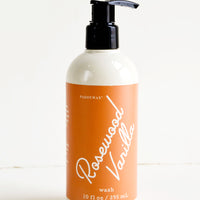 Rosewood Vanilla: Liquid soap packaged in ivory and black pump bottles with rust and white label