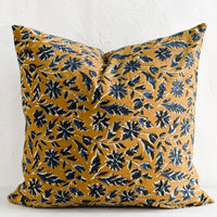 1: A block printed pillow with floral motif in blue and black on tan.