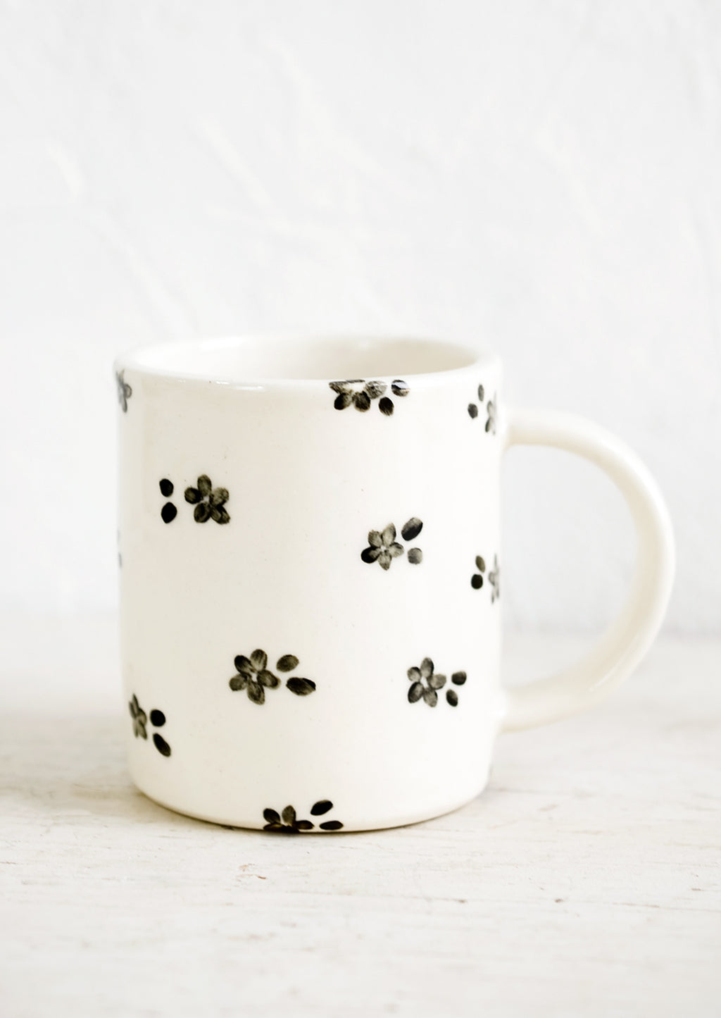 Black & White Floral: A handmade ceramic mug with white background and hand-painted black floral print.