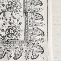 2: A block printed cotton tablecloth with black stitching and grey floral paisley pattern.