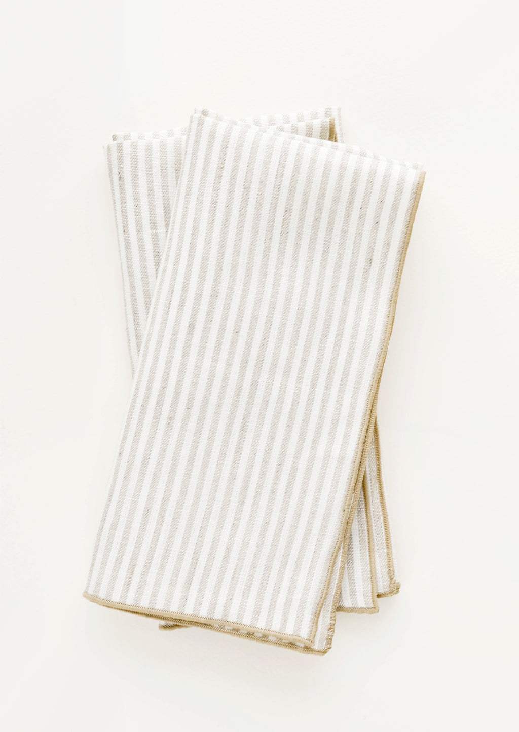 Flax Stripe: Pair of ivory folded Linen Napkins with light brown vertical stripe.