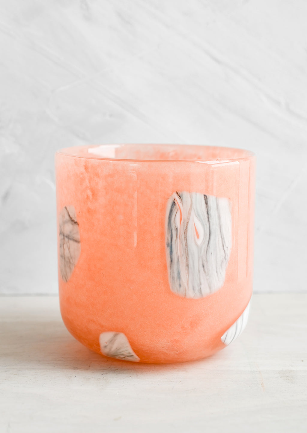 2: Peach glass cup with white and grey inlay pattern.