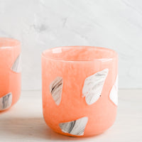 1: Peach glass cups with white and grey inlay pattern.