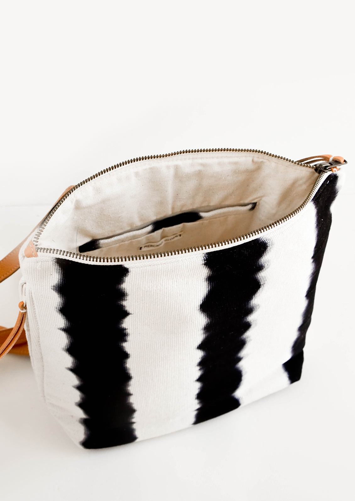 Inside of a fashion backpack with cotton canvas lining and interior slip pocket