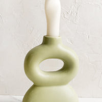 Honeydew: A curvy shaped taper candle holder in honeydew green.