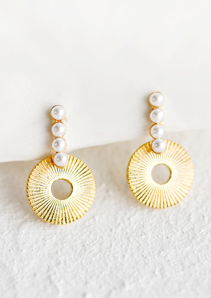 1: A pair of etched round circle earrings with four pearl post.