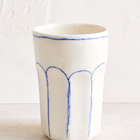1: A ceramic tumbler with blue lines.