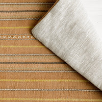 2: A throw pillow in clay stripe cotton fabric.