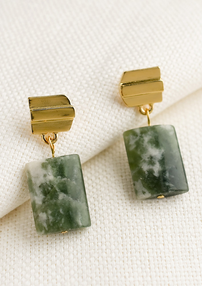 1: A pair of earrings with gold arrow shaped post and rectangular tree agate stone.