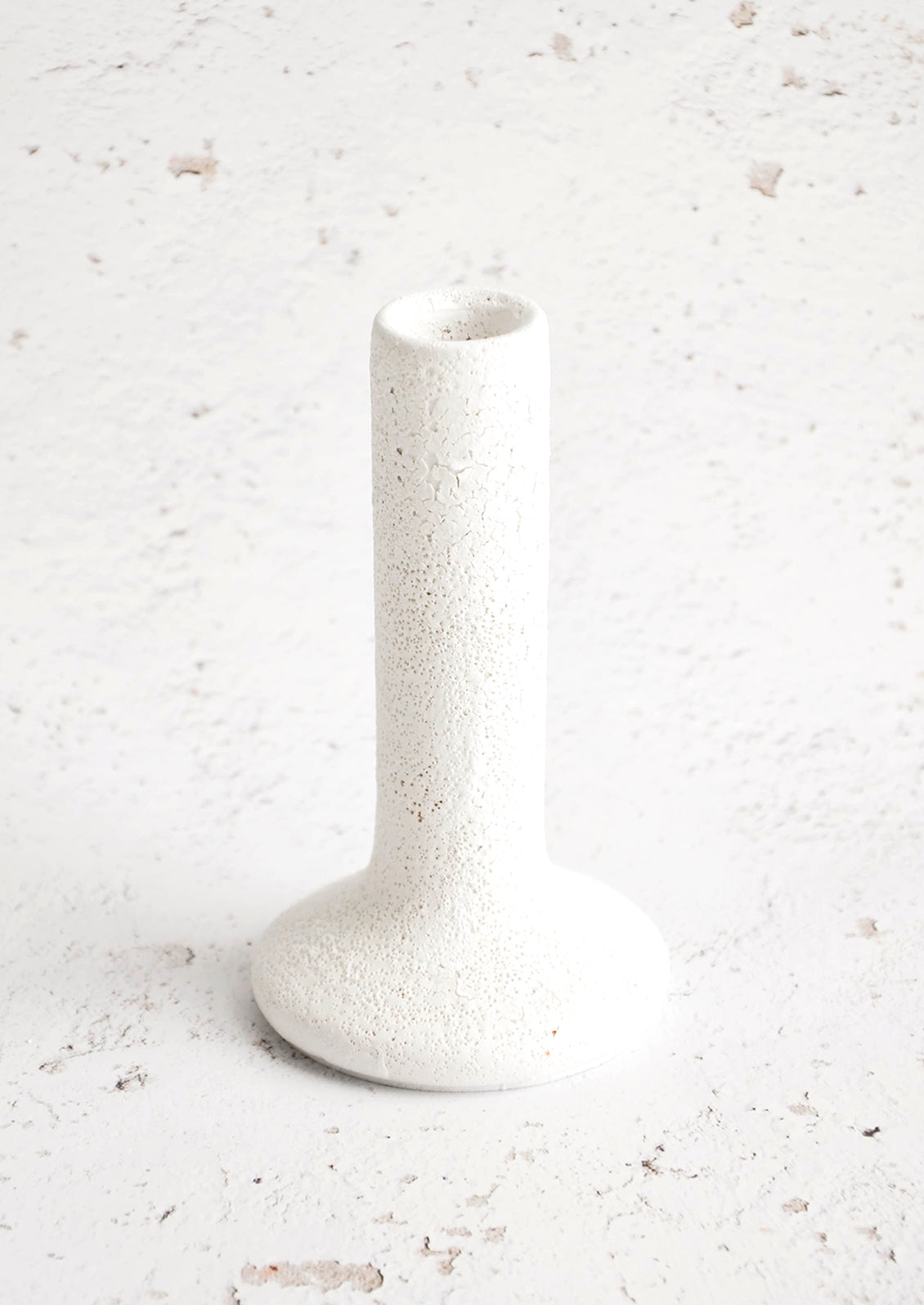 Tall white ceramic taper holder in bubble-textured rough white glaze