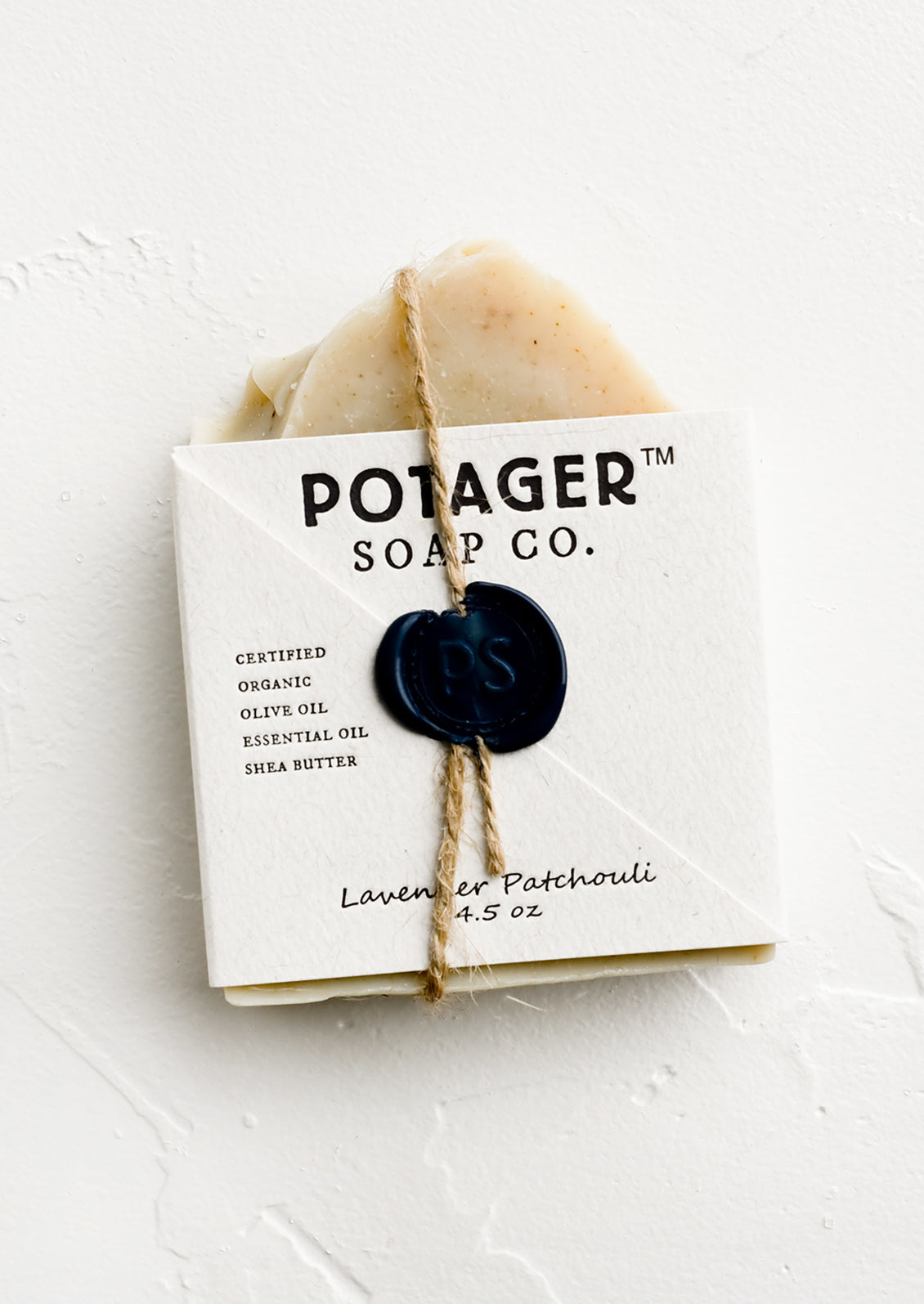 A bar soap in wax seal packaging.