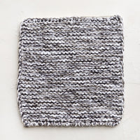 Grey Melange: A square, chunky knit cotton potholder in black and white marl.