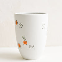 Large / Orange: A tall porcelain cup with hand drawn oranges.