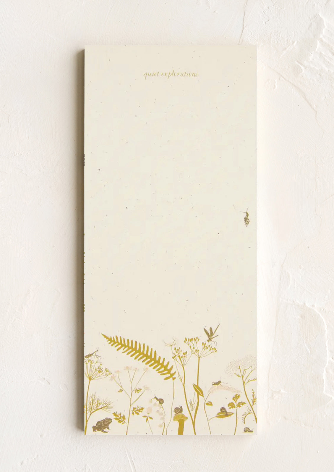 A list making notepad with "quiet explorations" printed at top with a decorative botanical border.
