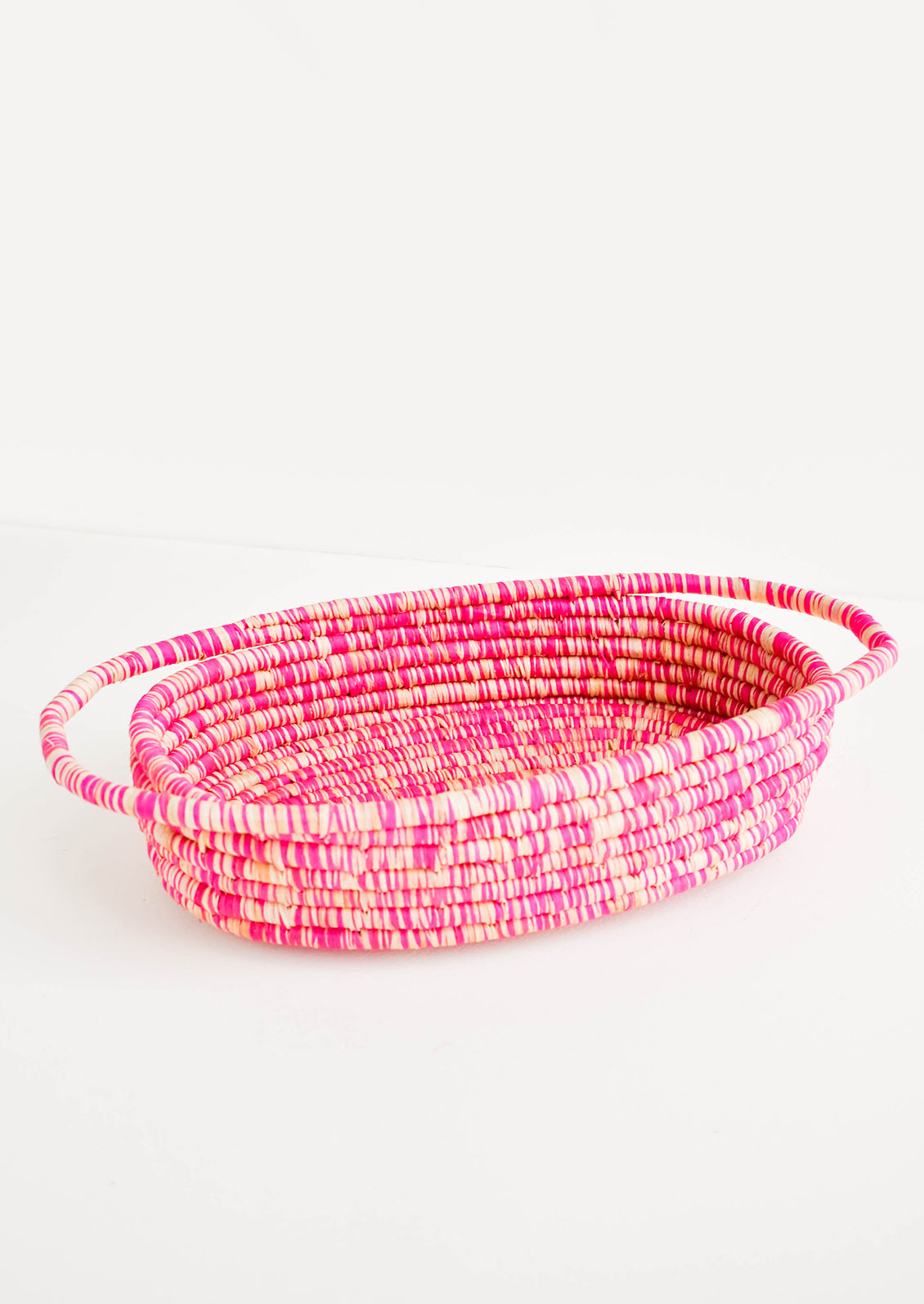 Oval Shaped, Shallow Raffia Basket with two handles at either end in Pink
