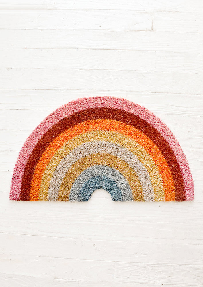 Doormat in the shape of a rainbow with colorful rays