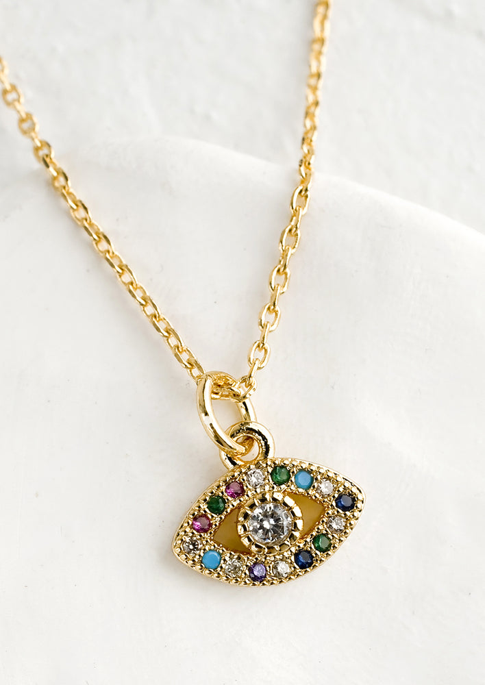 1: A gold necklace with evil eye charm.