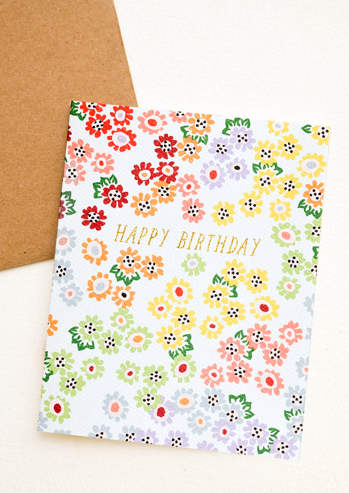 A floral print birthday card in rainbow colors.