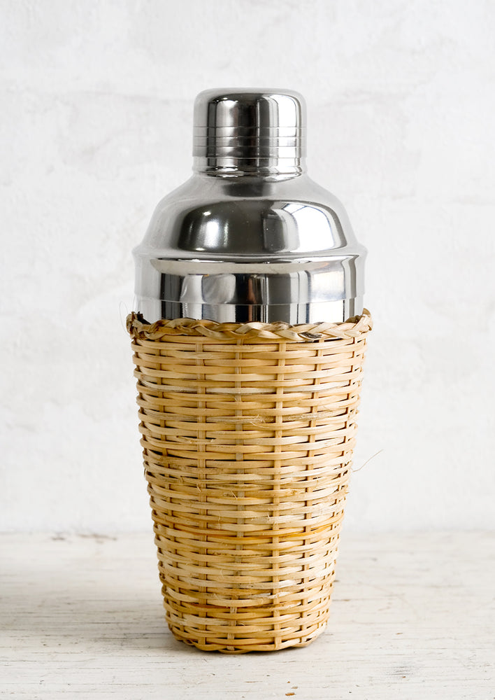 1: A stainless steel cocktail shaker with rattan cover.