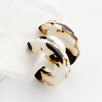 Coco Cream: A pair of acetate hoop earrings in brown and ivory.