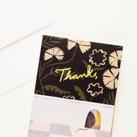 1: Greeting card with image of wall in a kitchen with a mouse hole, with "Thanks" in yellow text