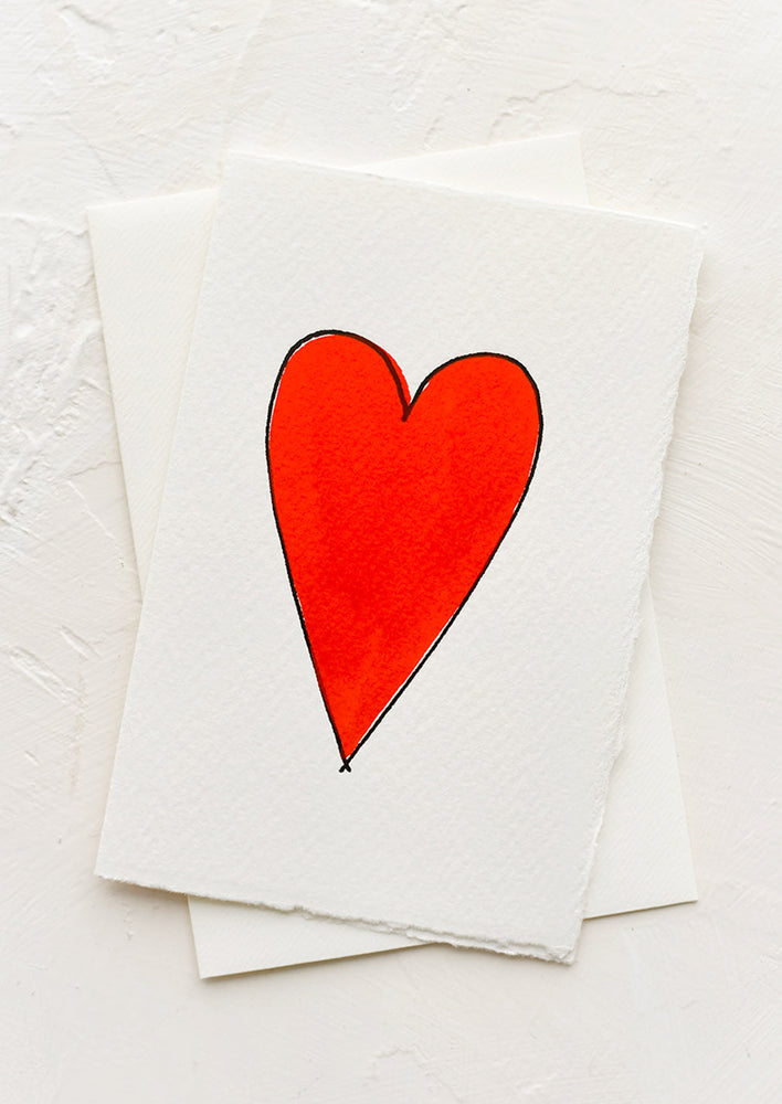 A greeting card with singular image of red heart.
