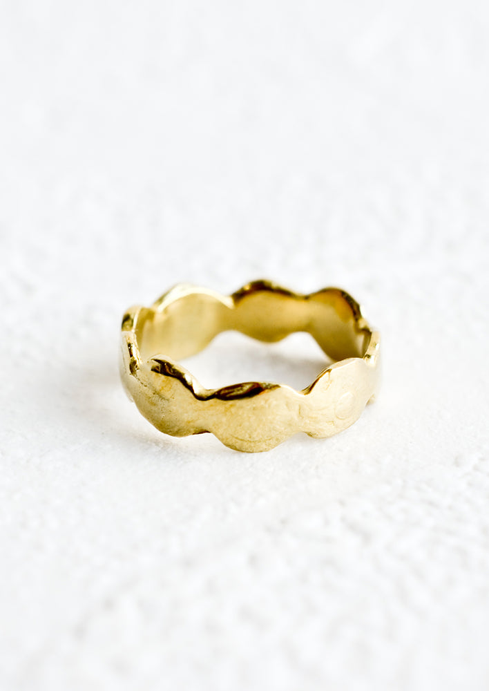 1: A brass ring in an organic, curvy shape.