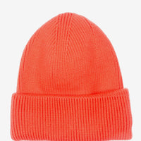 Coral: A knit beanie with oversized cuff in coral orange color.