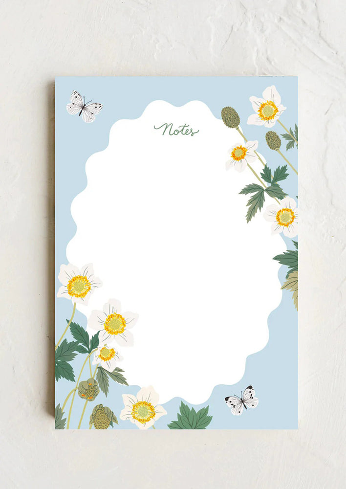 1: A notepad with ripple white section and floral butterfly print.