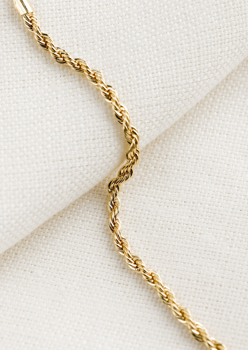 2: A gold bracelet in rope twist design.