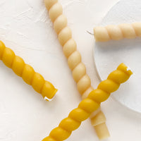 2: Taper candles in twisted rope design in two neutral hues.