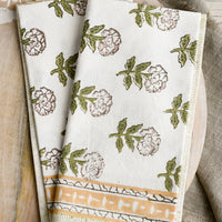 1: A pair of block printed floral napkins in green, mustard and lavender palette.