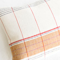 2: Throw pillow with intersecting stripes and embroidery
