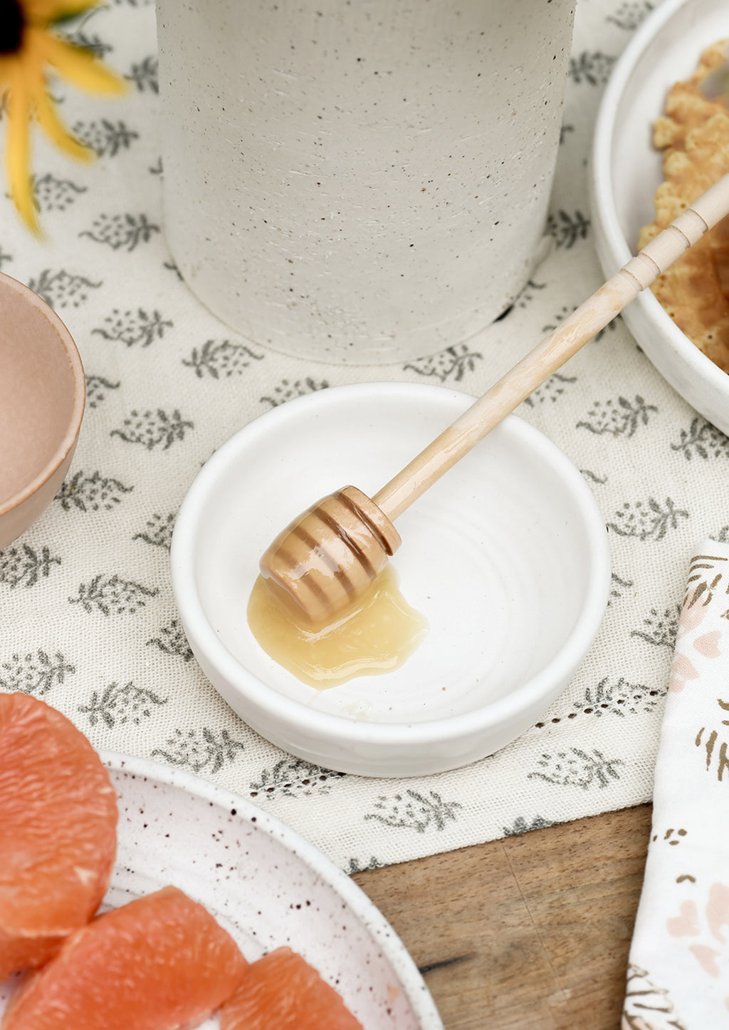 Matte White: A small white ceramic bowl with honey dipper.