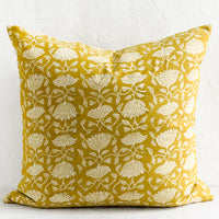 1: A pillow in yellow block print fabric.