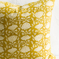 2: A pillow in yellow block print fabric.
