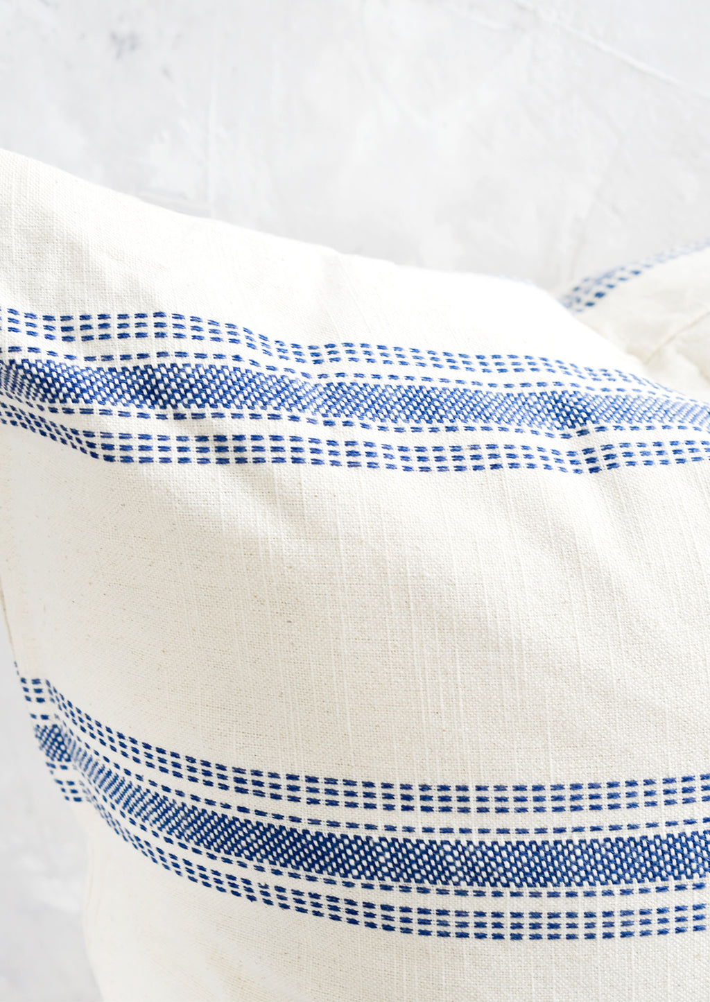 4: Blue embroidered stripe detailing on cream colored cotton.