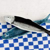 2: Ceramic trays in the shape of sardines.