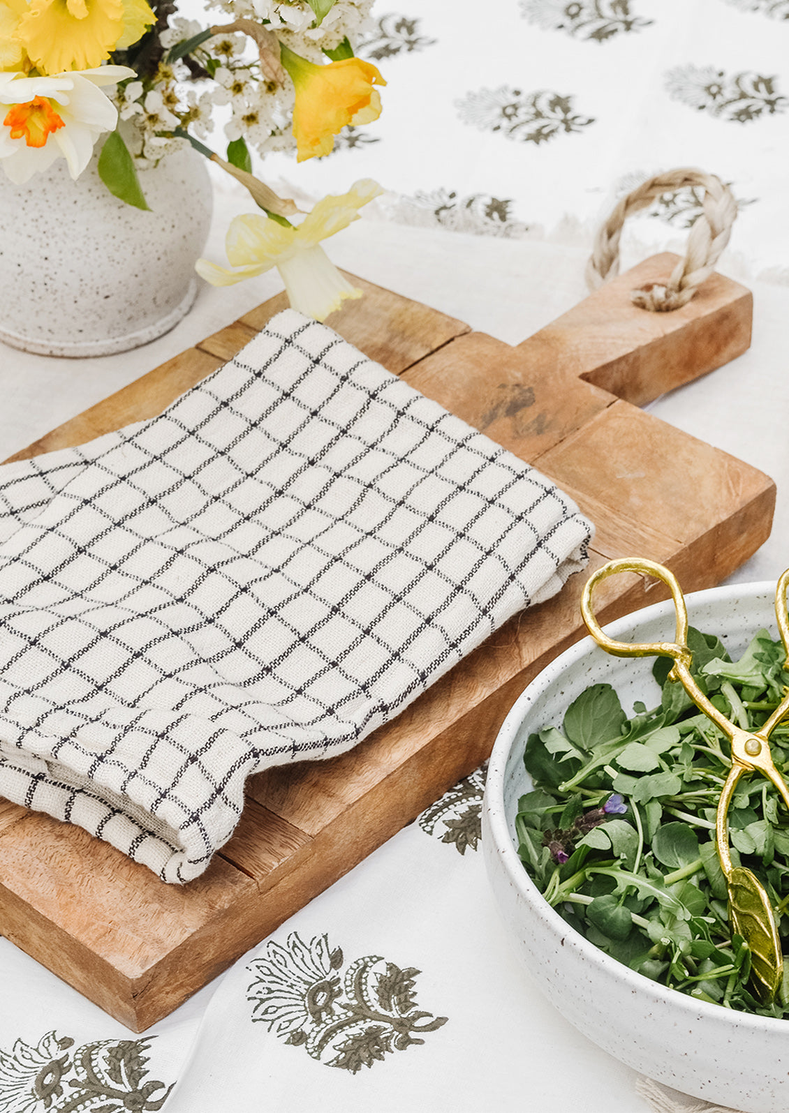 A tea towel on a wooden serving board.