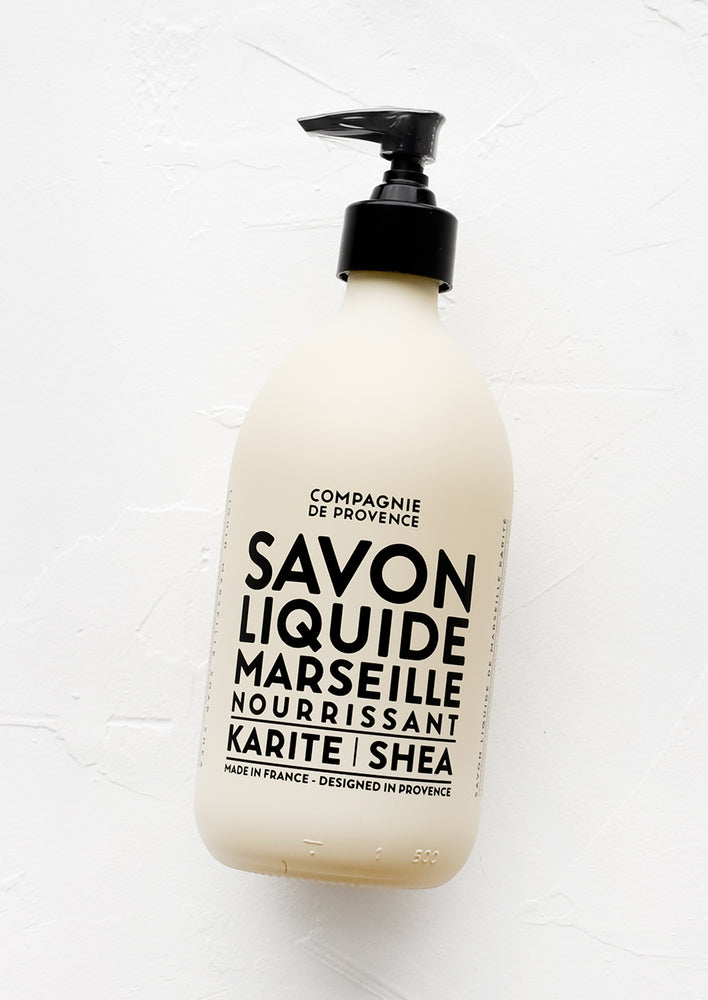 1: An opaque tan glass soap bottle with bold black text.