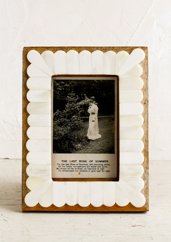 1: A wooden picture frame with white bone scalloped overlay.