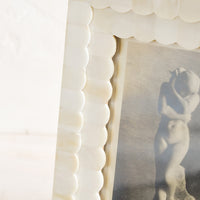3: A tabletop picture frame with scalloped ivory bone border.