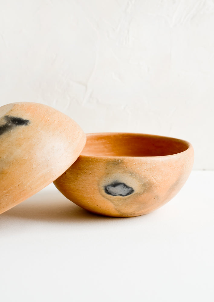 1: A red clay bowl with black scorch marks.