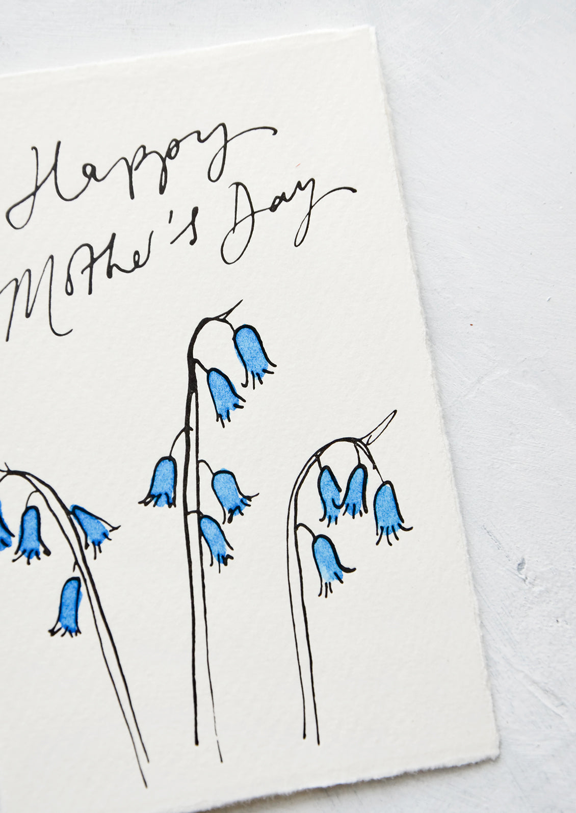 A greeting card made from hand-torn white paper