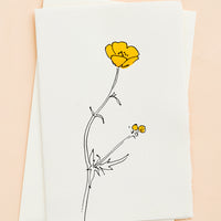 Buttercup: A white greeting card with a hand painted illustration of a buttercup flower.