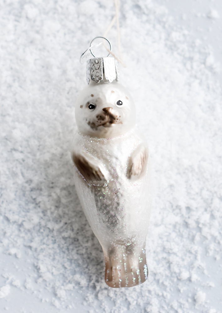1: A decorative glass ornament in the shape of a seal pup.