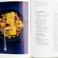 3: A cookbook open to a page with recipe for salmon masala with wild rice.