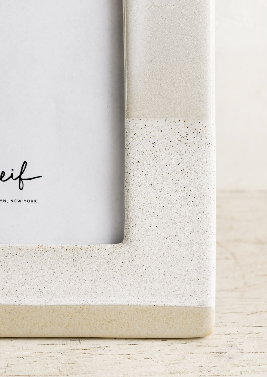 A ceramic picture frame in beige.